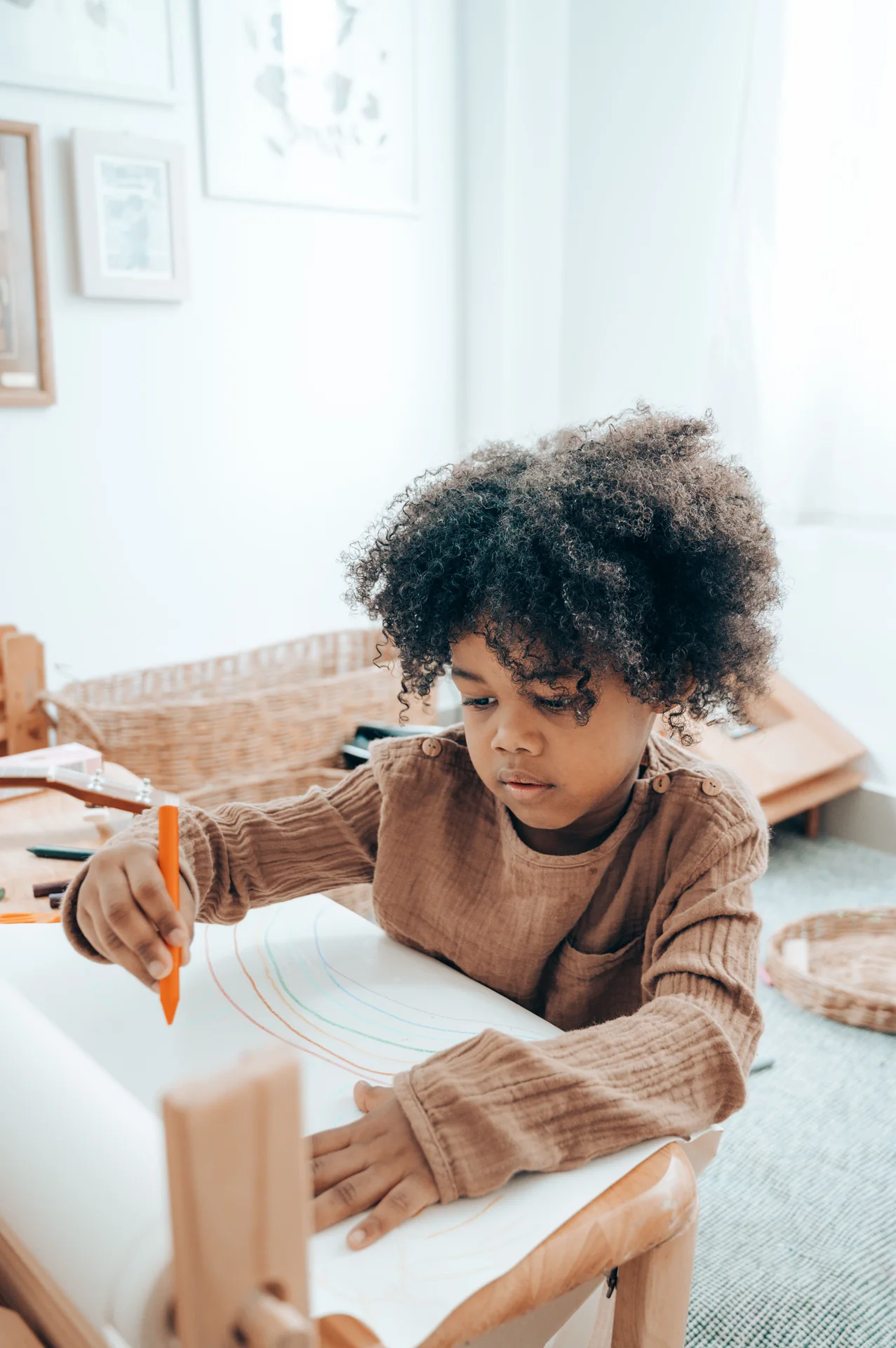 Young Black child focused on drawing independently